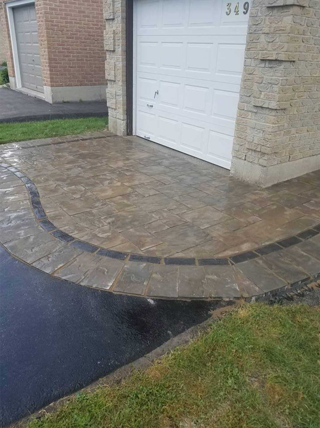 interlocking stone patio at top of driveway in front of garage