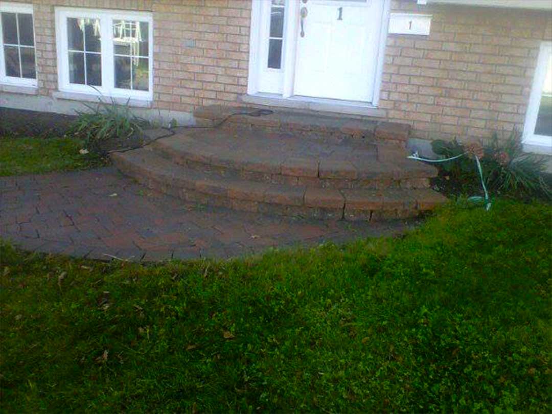 interlocking stone entrance with stone steps in front of residence