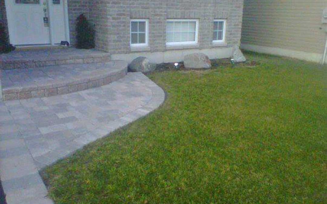 interlocking stone path and steps leading to front door of residence