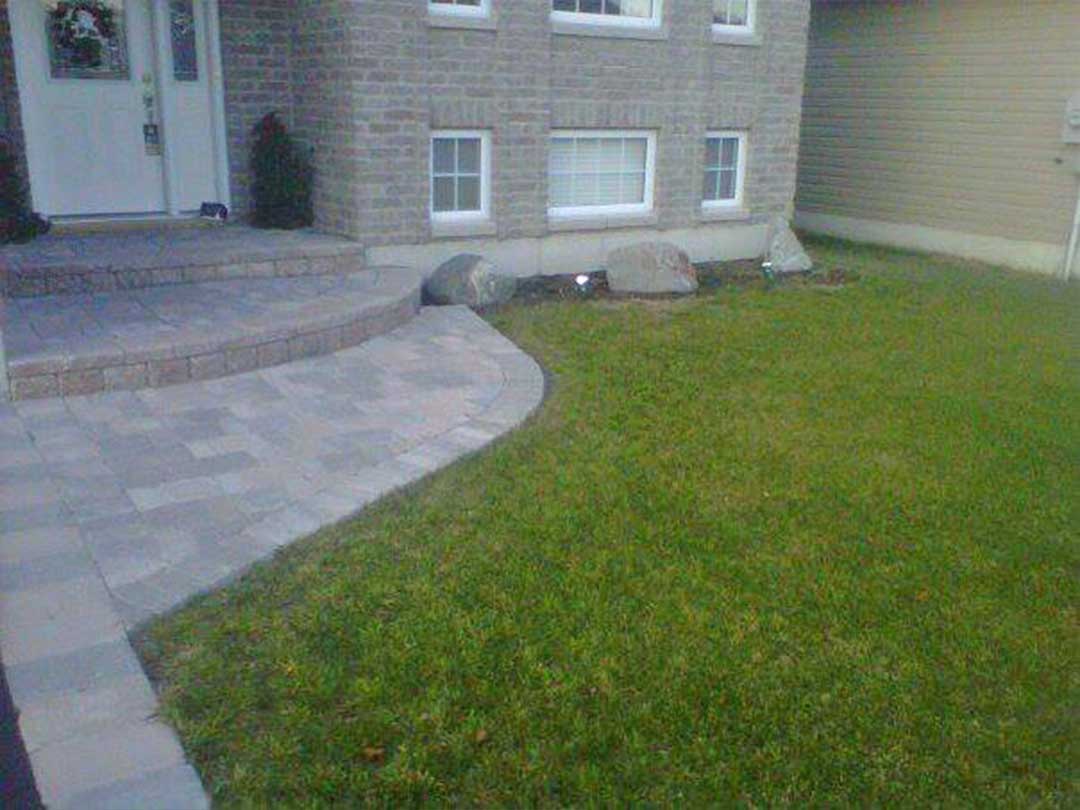 interlocking stone path and steps leading to front door of residence