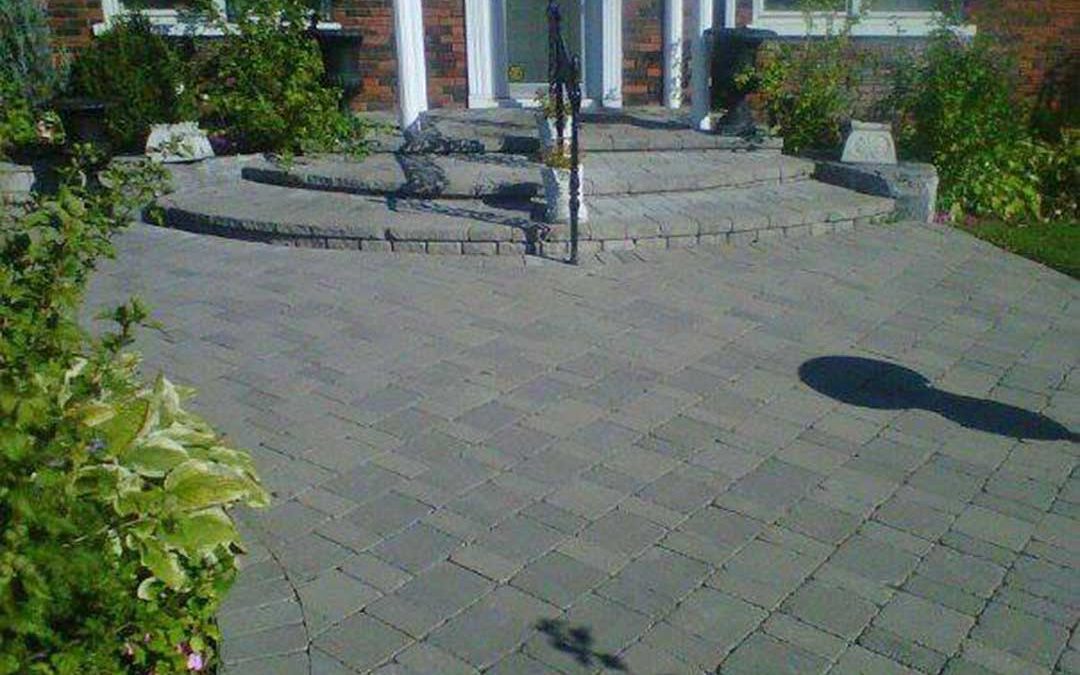 interlocking stone path and steps leading to front door of building