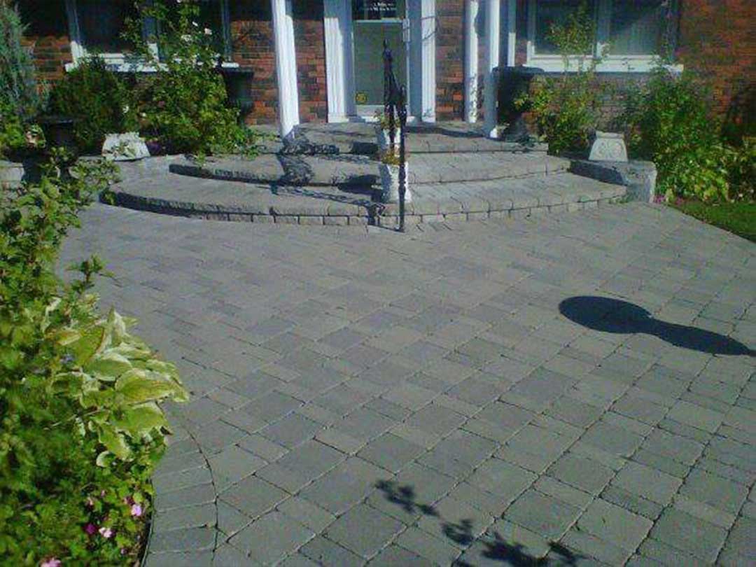 interlocking stone path and steps leading to front door of building