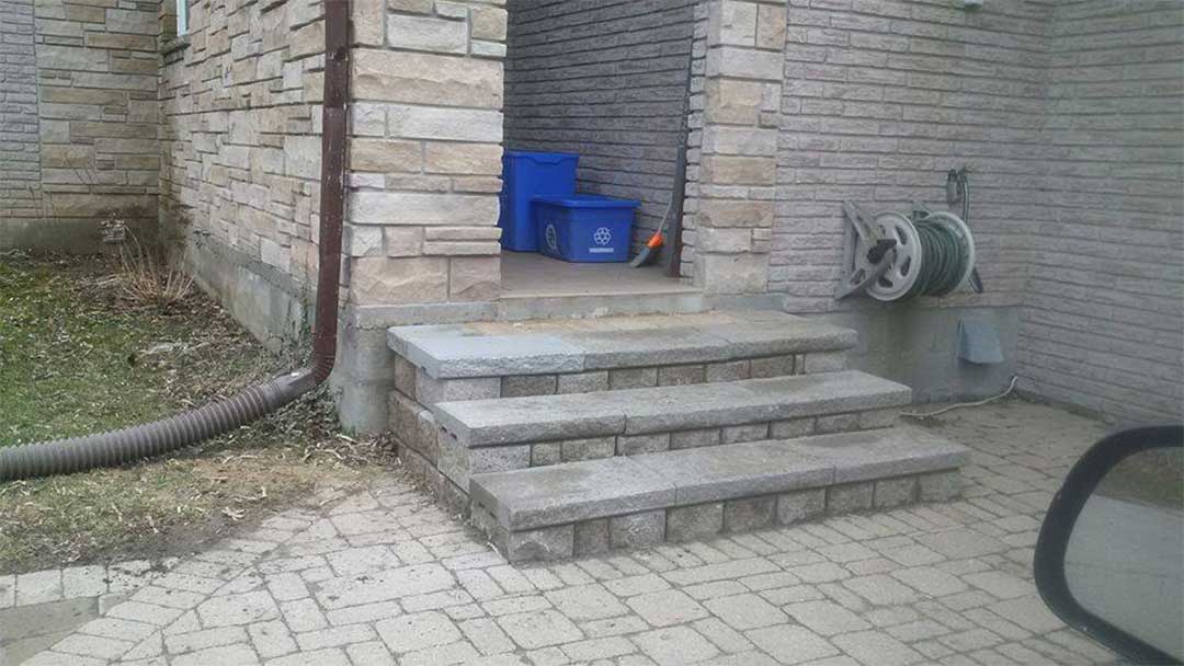 interlocking stone steps leading to front door of residence