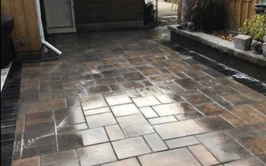 interlocking stone walkway and patio area in back of residence