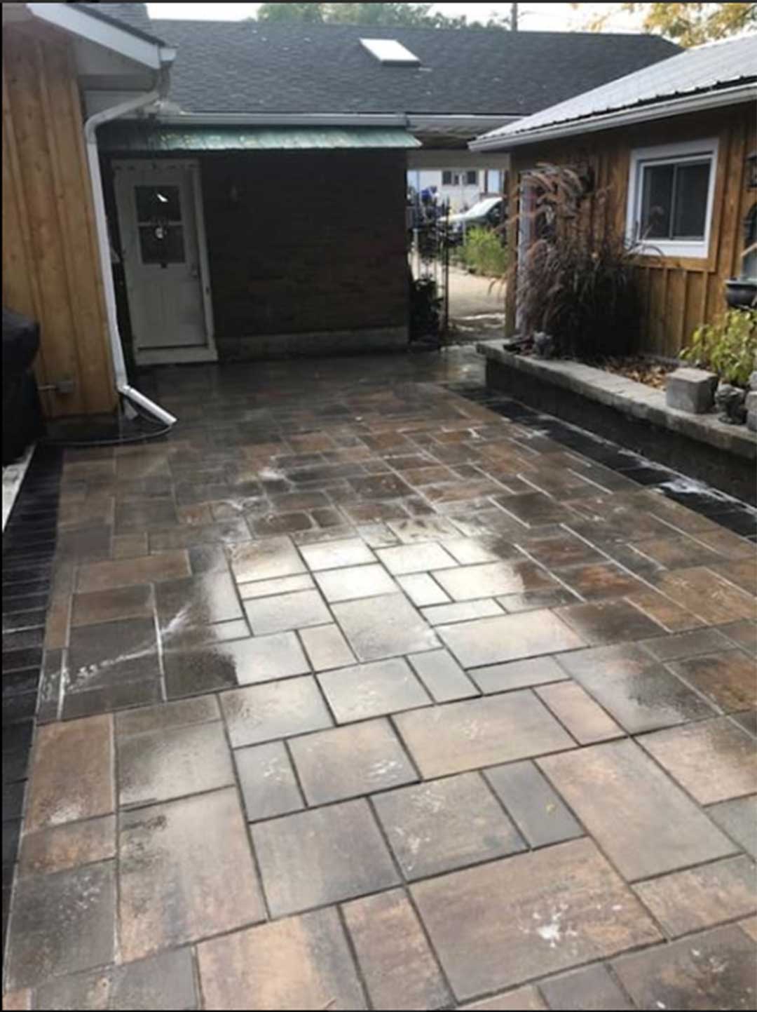 interlocking stone walkway and patio area in back of residence