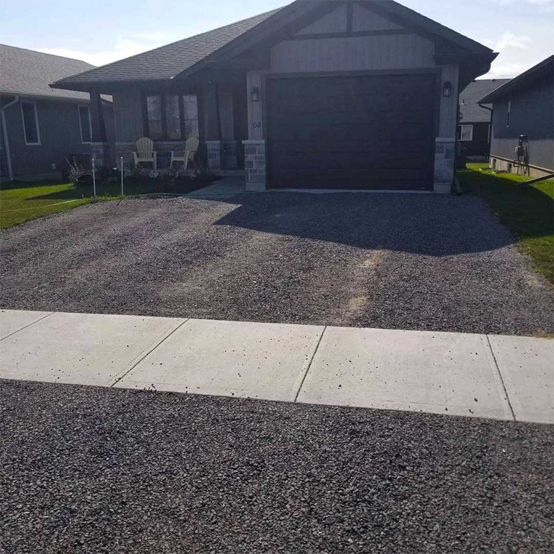 gravel driveway in front of residential home